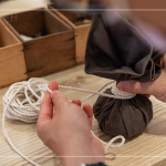 抓取藥材，包起、壓緊、編綁成球，感受草本植癒之外，還增添了另一份手感溫度，透過捶打、按壓，舒緩疲勞、釋放壓力。