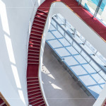 光線穿透玻璃，灑落在蜿蜒的紅毯旋梯上，從二樓延伸至五樓的曲線，讓建築不再只是結(jié)構(gòu)，更是一場光的藝術(shù)。